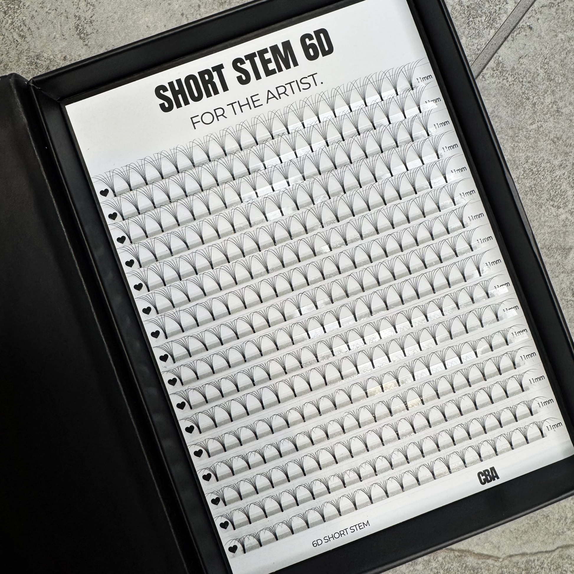 Eyelash extension tray labeled 'Short Stem 60' on a gray surface