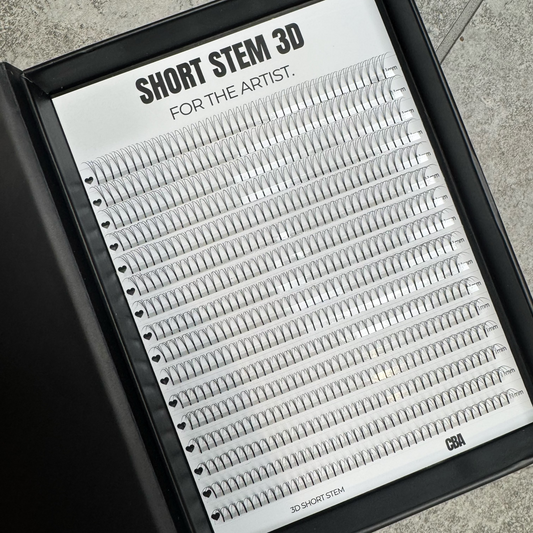 Eyelash extension tray labeled 'Short Stem 3D for the Artist' on a gray surface.