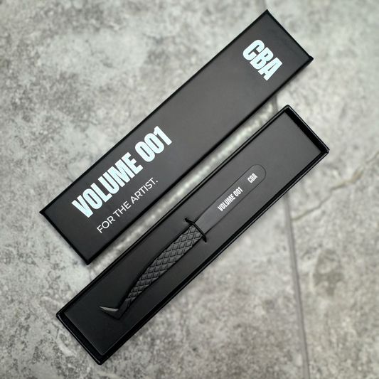 Black box with a textured object on a gray concrete surface